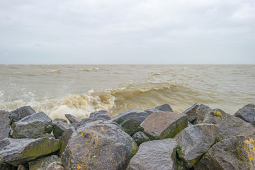 Dike along a stormy lake in winter