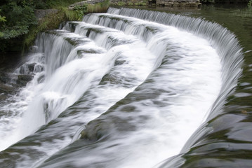 Obraz na płótnie Canvas Weir across the River Wye at Monsal Dale, Peak District, Derbyshire, UK