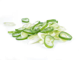Chopped spring onions on a white background
