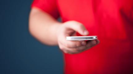 Young man holding smarthphone in hand