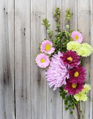Fototapeta na wymiar Springtime bouquet on wood background with copy space