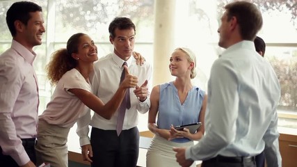 Business professionals celebrating team achievement