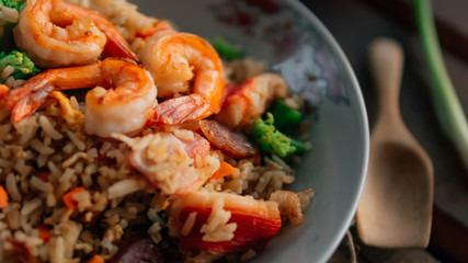 Vintage style Thai traditional food fried rice with shrimp on top and wooden background wallpaper
