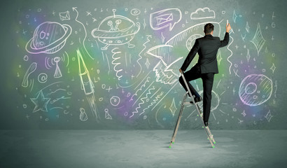 Young businessman drawing rocket