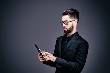 Portrait d'un jeune homme d'affaires, tenant une tablette tactile dans ses mains
