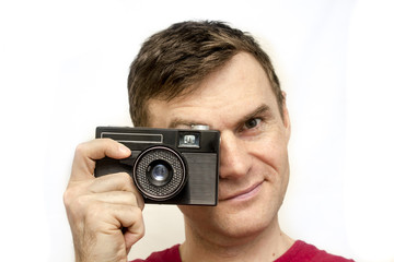 Fototapeta premium Man in a red shirt with old camera, white background