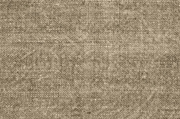 Fototapeta na wymiar Homespun hemp cloth. Close-up of texture fabric cloth textile background. Homespun hemp fabric material. Homespun hemp canvas. Natural authentic cloth. Beige colour.