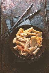 Appetizer Asparagus in Korean in a ceramic plate and chopsticks