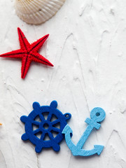 Background with decorative anchors and steering wheels on white painted wooden planks. Place for...