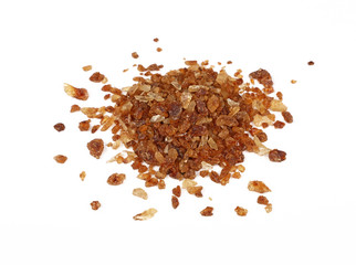 Pinch of brown caramel sugar spilled on white