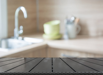 Blurred and abstract background. Empty wooden tabletop and defocused modern kitchen background for display or montage your products.