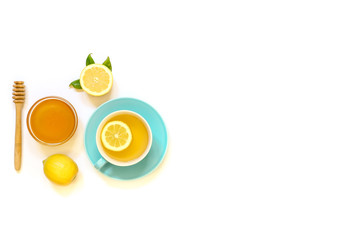 Cup of green tea with lemon and ingredients isolated on white background.