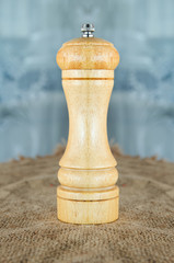 wooden pepper mill is on the table