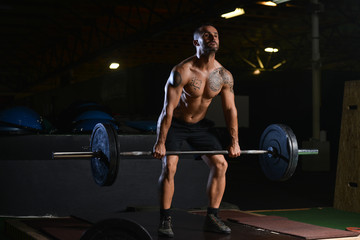 Bodybuilder Performing Back Exercising With Barbell In Gym