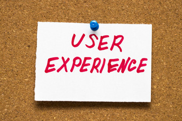 user experience written by hand, hand writing on corkboard