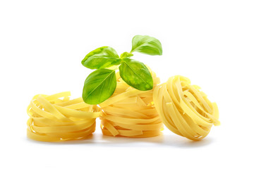 Italian pasta with basil isolated on white background