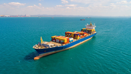 container ship in import export and business logistic.By crane ,Trade Port , Shipping.cargo to harbor.Aerial view.Top view.