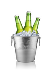 Green bottles of beer in ice bucket isolated on white background