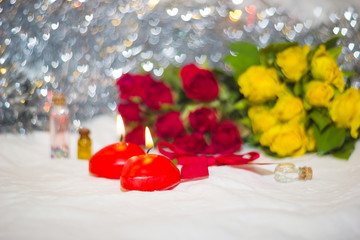 candles and roses on background