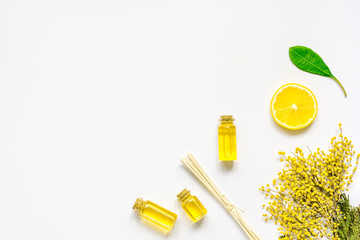 cosmetic spa set with oils and lemon white background top view mock-up