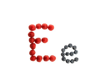 Alphabet from fresh fruit, raspberry and blackberry, isolated on a white background