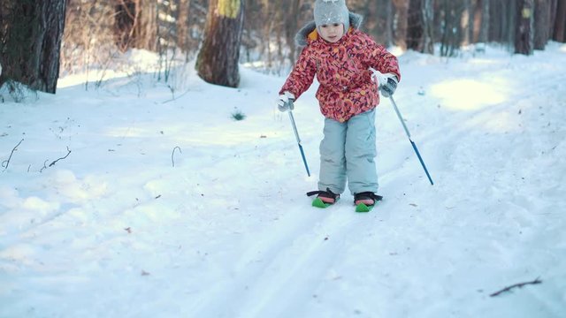 A little girl is learning cross country skiing