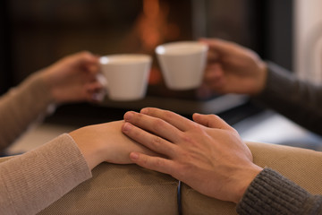 Young couple  in front of fireplace