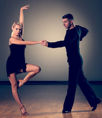 Beautiful ballroom couple preforming their pasonate exhibition dance