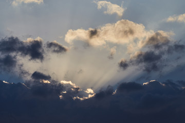 Naklejka na ściany i meble Sun rays in the clouds