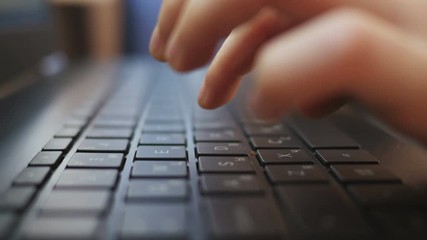 Close-up of children's hands typing on a keyboard - Powered by Adobe