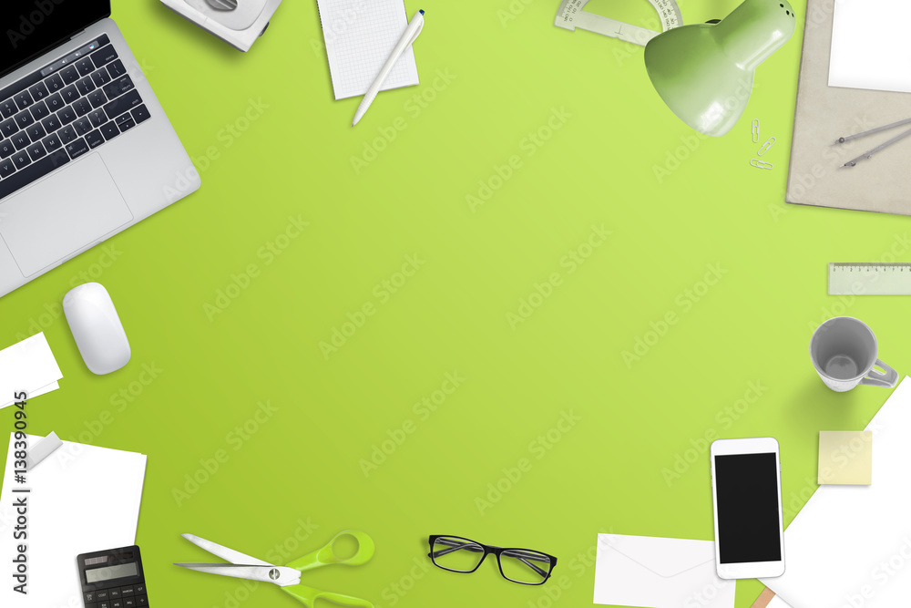 Poster mess on office desk with free space for text. laptop computer, smart phone and office work accessori