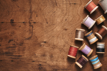 vintage spools of thread on a distressed wood surface