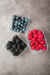 Various fresh summer berries. in plastic containers Top view