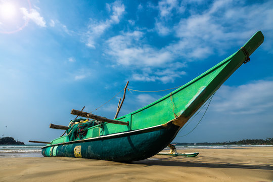Fishing boat and fishing net on the ocean coast of Sri Lanka vintage nature background