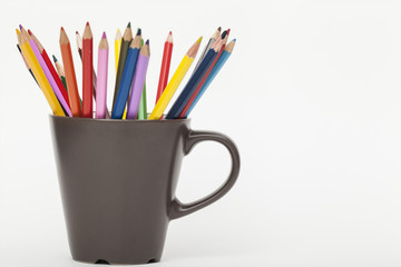 colored pencils in a brown circle on a white background