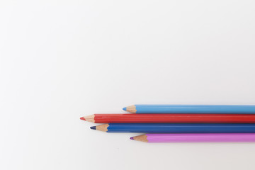 colored pencils in red and blue on a white background. the concept of family.