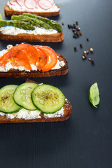 Four different sandwiches on black board