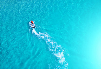 People are playing a jet ski in the sea.Aerial view. Top view.amazing nature background.The color...