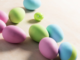 Pastel Easter eggs on wooden table.