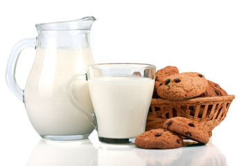 jug and glass of milk with oatmeal cookies in a wicker basket isolated on white background
