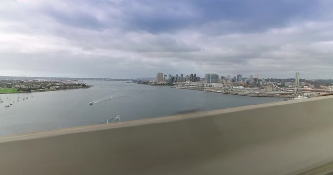 A side profile view of the skyline of San Diego while driving on the Coronado Bridge on an overcast Winter's day.  	