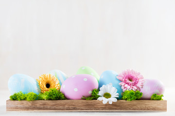 Easter decoration - eggs and flowers on a wood