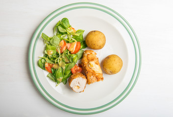 Kiev cutlet with jacket potatoes and salad