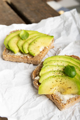 Sandwich with avocado slices and basil
