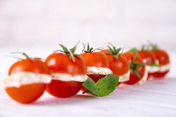 Sliced cherry tomato and mozzarella with basil leafs. Burger style