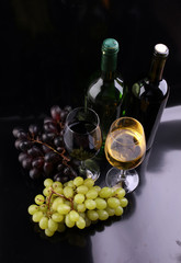 Fototapeta premium Wine glass and Bottle on black background. Red and white wine