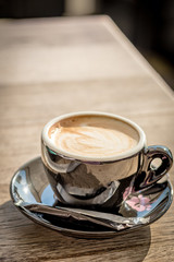Coffee espresso in black mug on table