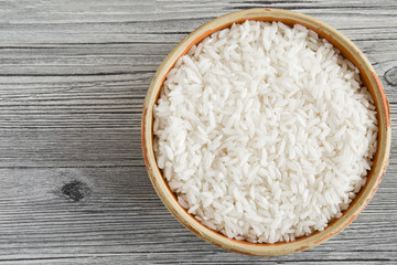 Rice in the dish on the wooden table. Healthy eating and lifestyle.