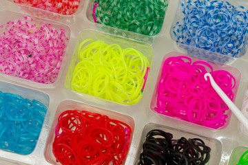 Rubber bands to weave bracelets and hook in a box