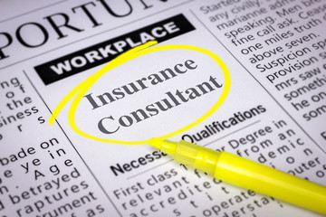 Insurance Consultant - Newspaper sheet with ads and job search, circled with yellow marker, Blurred image and selective focus